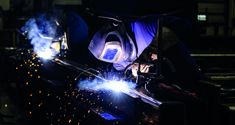 a professional welder actively working in a factory