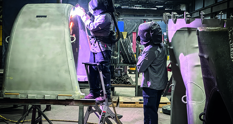 industrial metal fabrication workers performing TIG welding on large components