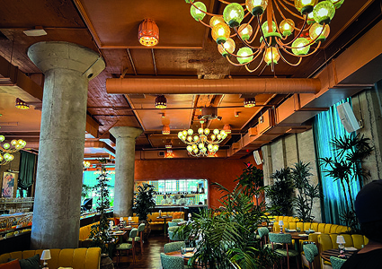 A prominent, large circular duct runs horizontally across the ceiling