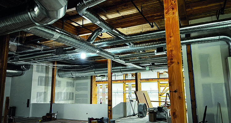a commercial HVAC duct installation in a building under construction.