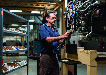a man working on machinery in a factory