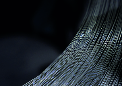 a close-up, reflective texture of coiled spring steel