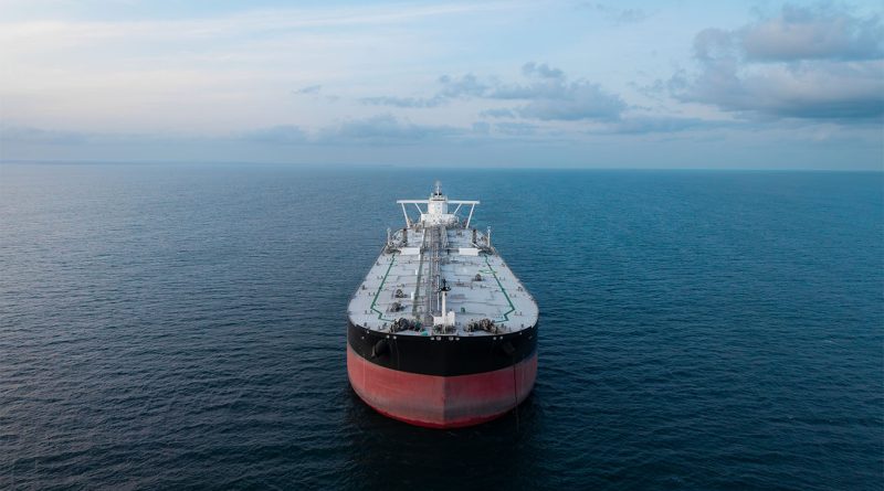 Cargo ships navigating a major shipping route amid rising oil price volatility