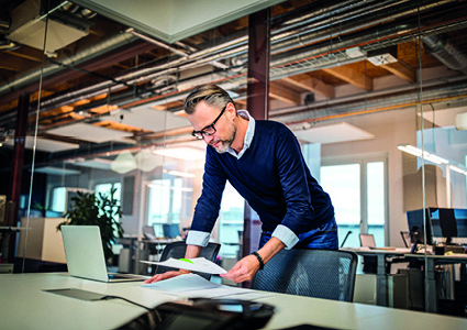 a man in a modern, open-plan office environmen