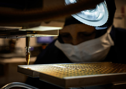 a technician working with precision laser manufacturing technology