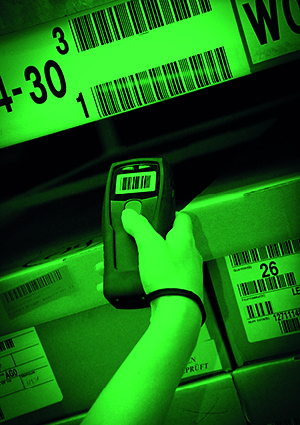 a worker utilizing a handheld barcode scanner to manage stock in a logistics and storage facility