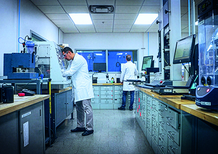 two scientists working inside a modern, well-equipped laboratory environment.