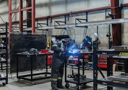 a fabrication shop where a worker is metal welding