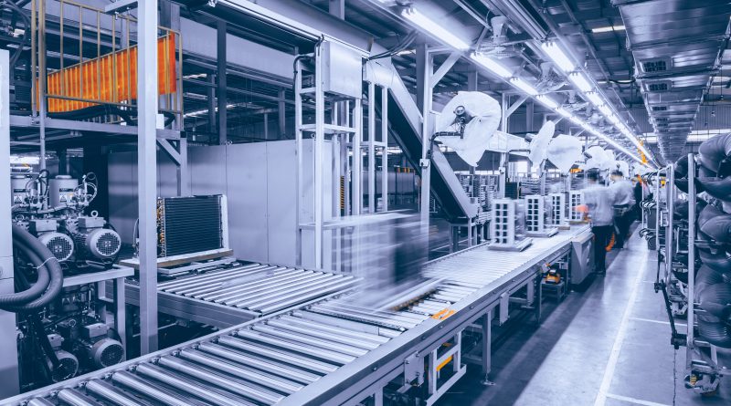 A modern manufacturing facility with automated production lines representing the impact of global competition, trade policy and industrial investment decisions.