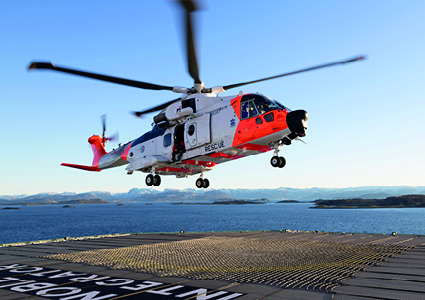 a search and rescue helicopter taking off from or landing on a ship's helideck.