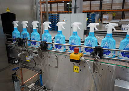 an automated production line packaging household cleaning products inside a manufacturing plant