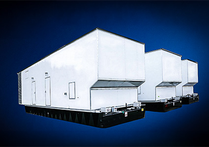 three large, identical industrial modular utility enclosures lined up in a row.