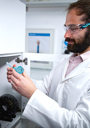 a laboratory technician or researcher examining a piece of medical or laboratory equipment
