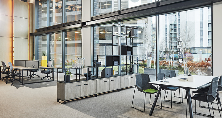 a spacious, modern open-plan office interior with distinct, collaborative workspaces
