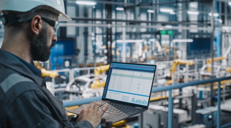 worker studying iPad in factory