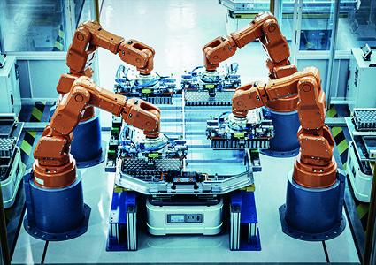an automated industrial assembly line featuring four large orange robotic arms.