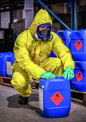 a worker handling hazardous materials inside a storage facility