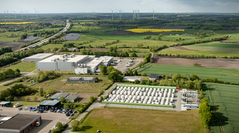 Aerial view of industrial energy storage facility by agricultural fields and renewable energy landscape