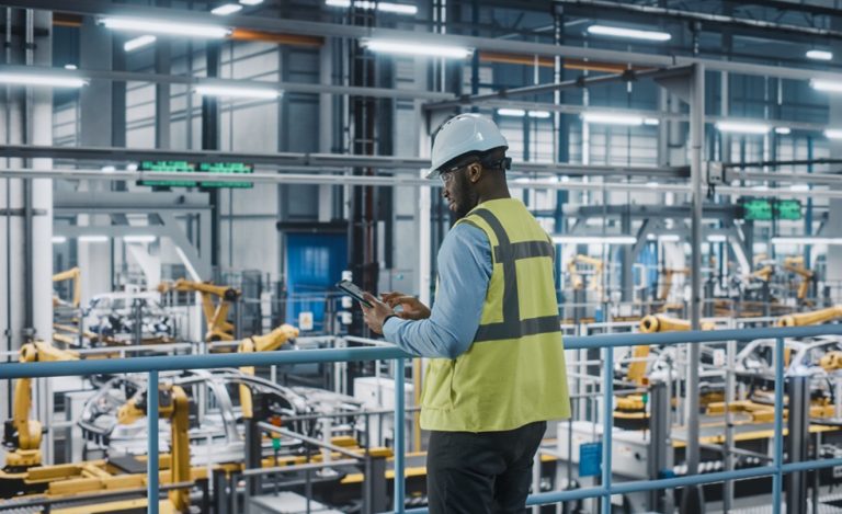 manufacturing worker studying tablet