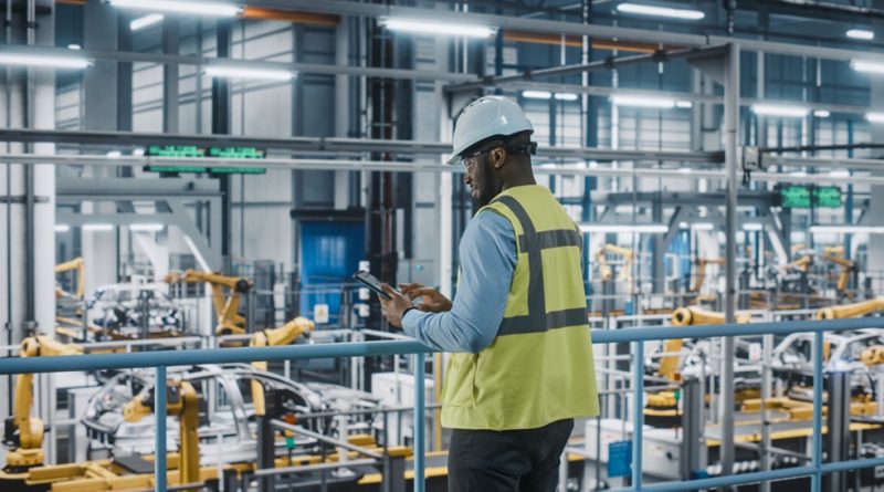 manufacturing worker studying tablet