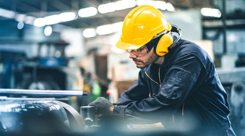 Factory workers oversee automated production equipment as US manufacturing activity reaches its highest level in more than four years.