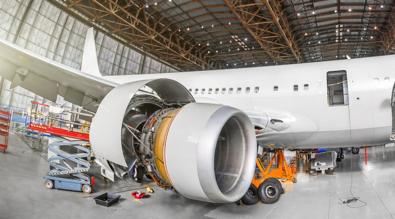 Passenger aircraft on maintenance of engine and fuselage repair in airport hangar.