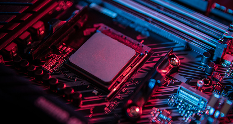 a close-up of a central processing unit installed inside the CPU socket on a computer motherboard, bathed in red and blue neon lighting