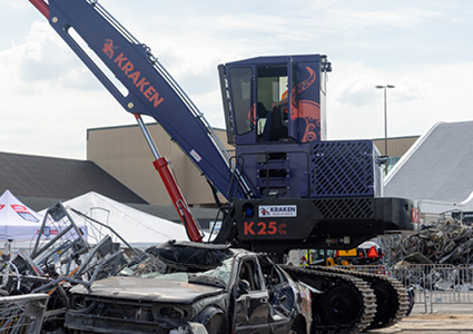 a heavy-duty Kraken K25C crawler scrap material handler with a blue and black finish