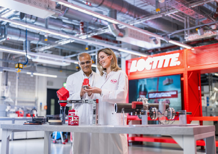 two scientists in a modern industrial laboratory setting working with Loctite products