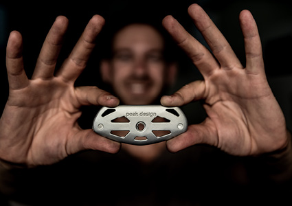 an early prototype or design element of the Peak Design Capture Camera Clip being held up by founder Peter Dering