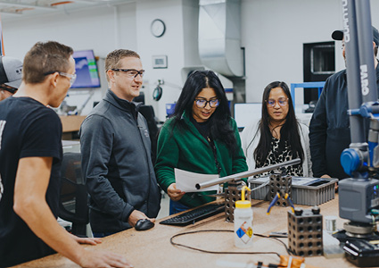 a team working together in an engineering or technical workshop