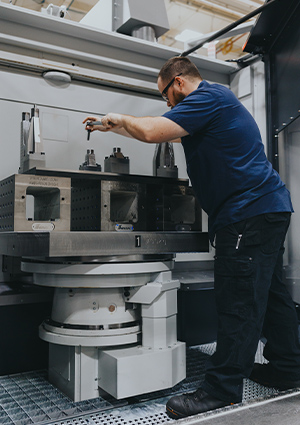 an operator working on a large 5-axis horizontal machining center