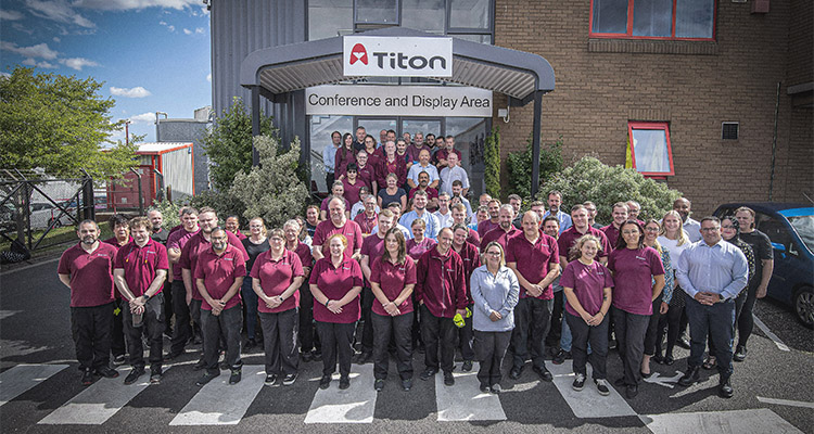 a group photograph of employees outside the Titon Hardware facility on Falconer Road in Haverhill, Suffolk